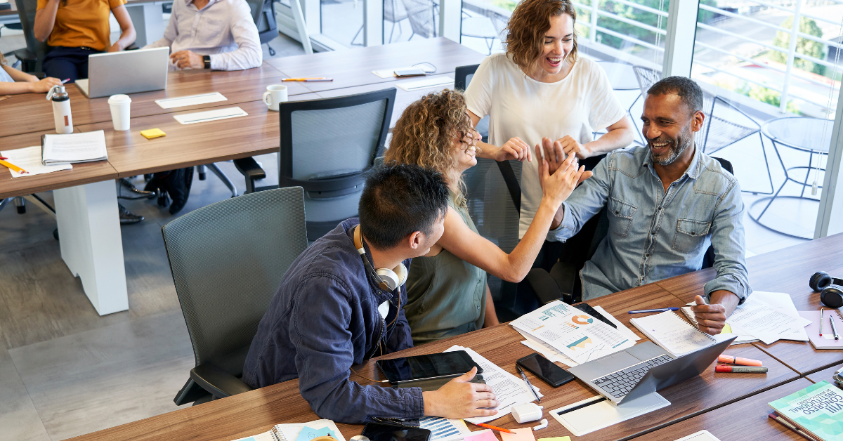 A team of happy people meeting in an open work environment.