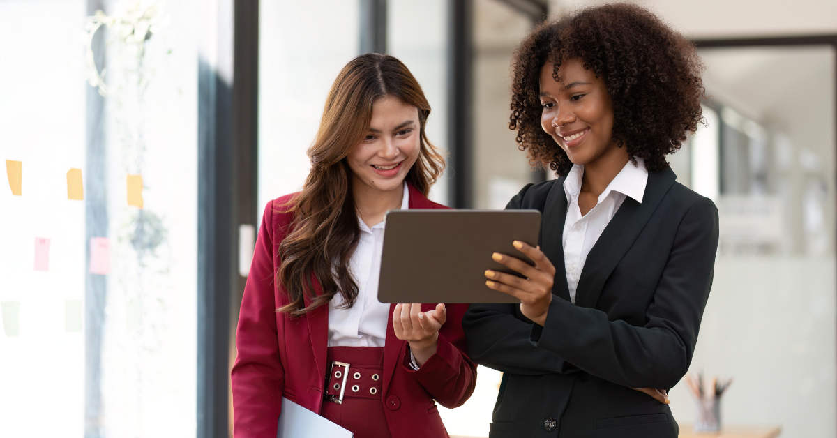 Two co-workers review the personalization metrics for a client website. They are both very happy with the performance.