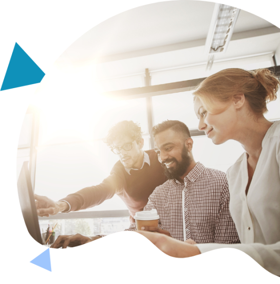 A group of three professionals collaborating at a computer, discussing Adobe Implementation project details with sunlight in the background.