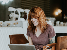 Tattooed woman with laptop