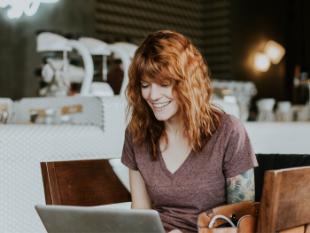 Tattooed woman with laptop